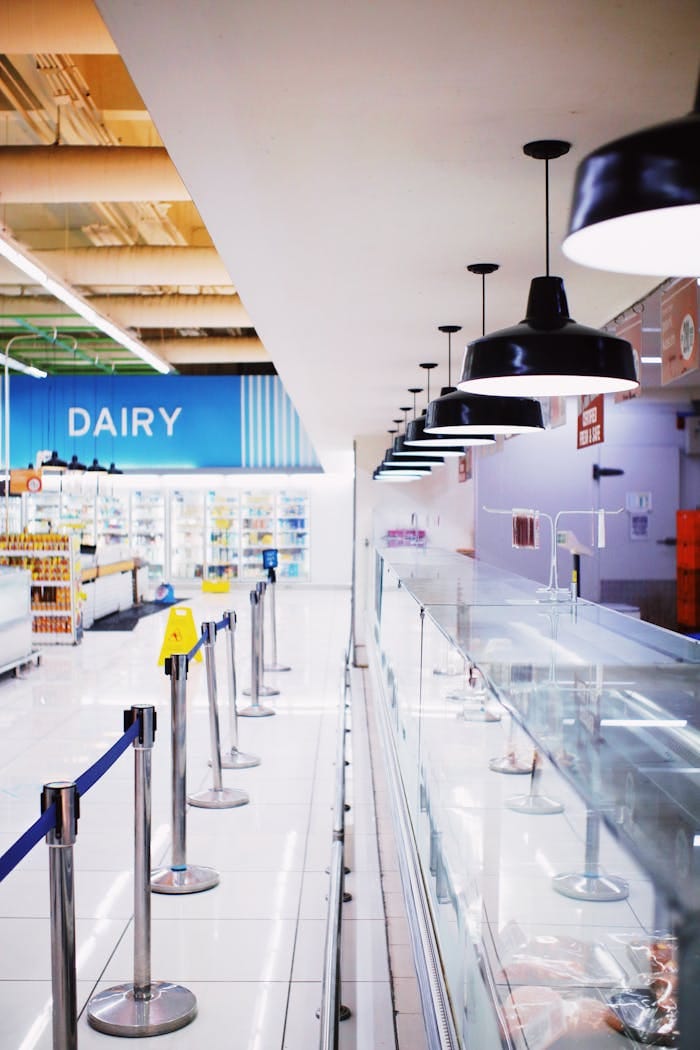 Modern supermarket interior showcasing illuminated dairy aisle with sleek design.